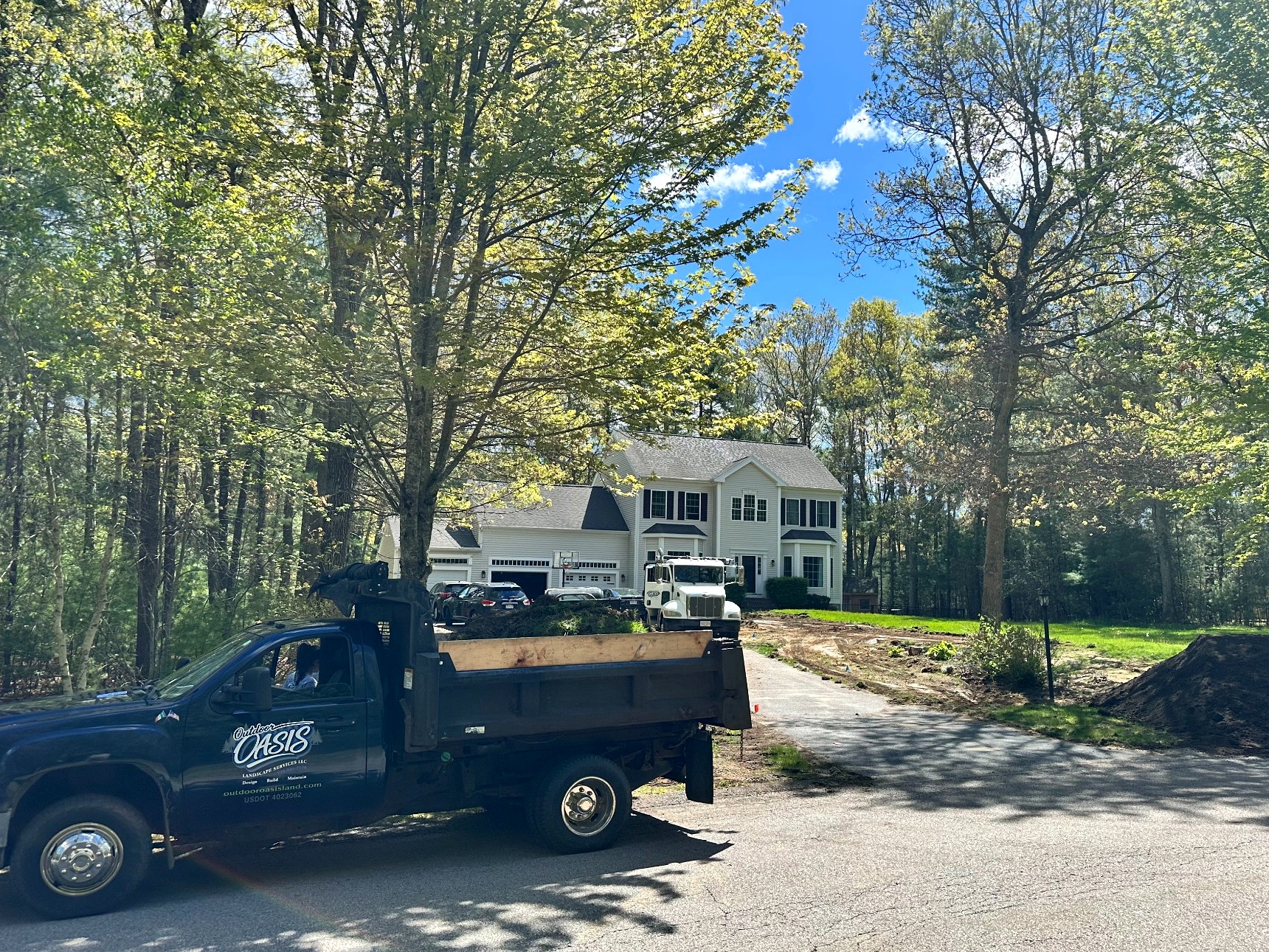outdoor-oasis-dump-truck-new-lawn-installation-south-shore-ma-4x3